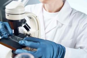 woman laboratory assistant microscope diagnostics research microbiology photo