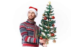 Cheerful man in a santa hat Christmas decorations holiday New Year studio posing photo