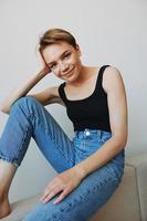 Young woman with short haircut hair having fun at home on the couch smile and happiness, vacation at home, natural posing without filters, free copy space photo