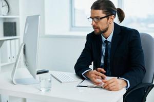 office worker sitting at a desk in front of a computer Lifestyle photo