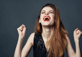 energetic red-haired woman gesturing with hands joy delight emotion photo