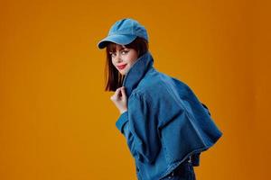 pretty woman in a cap and denim jacket posing studio model unaltered photo