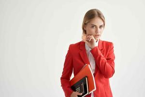 financier in a red jacket with documents in hand light background photo