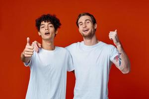 two man in white t-shirts fun emotions hand gestures friendship hugs photo