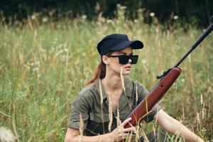 mujer soldado Gafas de sol con brazos en abrigo armas foto