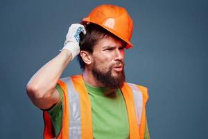 worker man in construction uniform professional lifestyle blue background photo