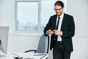 man in a suit documents in hand communication by phone executive photo