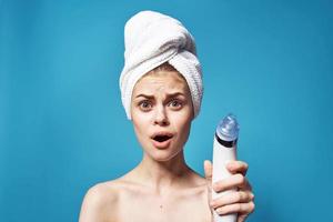 cheerful woman with a towel on her head removing blackheads skin care photo
