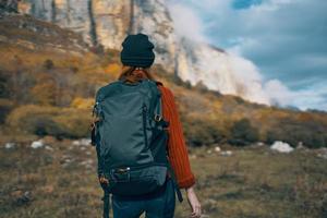 travel tourism woman with backpack high mountains sky landscape photo