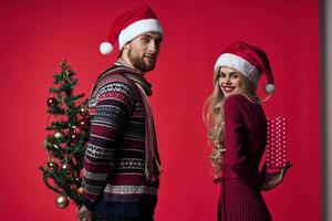 man and woman christmas holiday romance red background photo