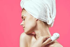 woman with bare shoulders and skin cleaning cosmetology health pink background photo