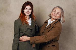 Mom and daughter in coat posing fashion autumn style photo