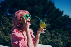 fashionable woman enjoying a colorful cocktail hotel terrace Relaxation concept photo