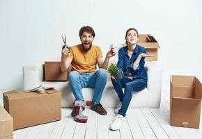 Young couple with boxes of things tools room interior photo