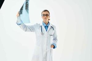 woman radiologist in lab coat looking at x-ray diagnostics hospital photo