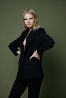 Women 's Power and the women 's movement for Feminism concept . A cool strict successful strong girl in an elegant suit keeps her hands on her waist. Look at me offer photo