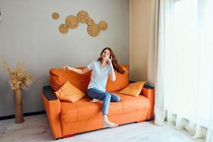 cheerful woman on the couch rest fun Comfort apartments photo