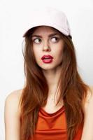 Woman in a cap looks to the side with open mouth attractive look photo