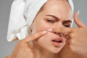 woman with towel on head bare shoulders facial close-up photo