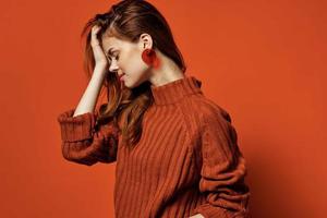 cheerful woman in red sweater earrings charm cosmetics model photo