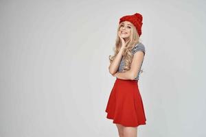 beautiful woman in fashionable clothes Red Hat posing Studio photo