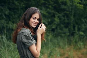 Woman outdoors smile look forward fresh air travel countryside green leaves photo