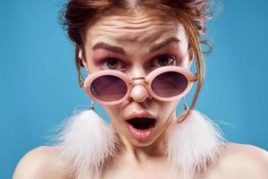 woman bare shoulders fluffy earrings fashion glasses close-up photo