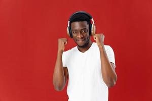 smiling african man with headphones listening to music photo