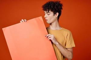 a guy in a yellow T-shirt with an island in his hands Copy Space advertisement photo