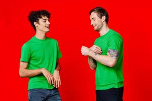 Cheerful friends in green t-shirts hugs communication photo