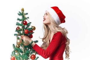 woman with christmas tree in hands toys holiday christmas decoration photo