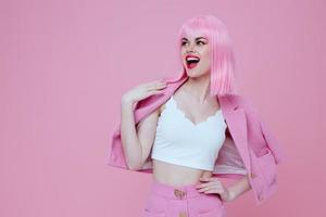 Portrait of a charming lady bright makeup pink hair glamor pink background unaltered photo