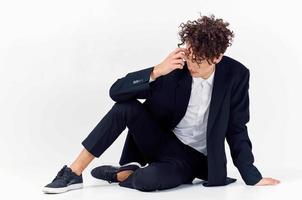 guy in black jacket sitting on the floor fashion elegant style photo