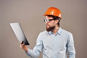 Man in orange hard hat professional safety manual documents work photo