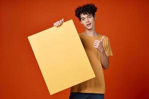 guy with curly hair studio advertising mockup red background photo