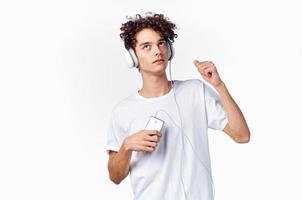 emotional guy with curly hair in headphones listening to music fun photo