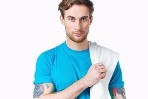 man in blue t-shirt towel on shoulder cropped view color background fitness photo