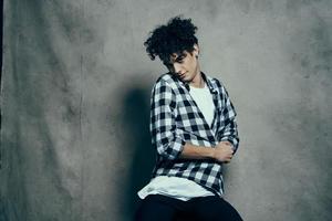 handsome man in plaid shirt fashion curly hair modern style photo