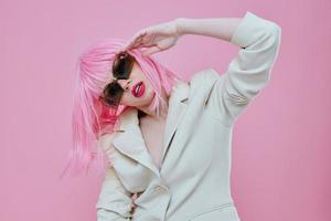 Young woman wearing sunglasses pink hair posing color background unaltered photo