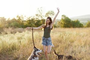 Woman and her husky dog happily walking and running in the grass in the field smile with teeth autumn sunset walk with a pet, traveling with a friend dog happiness photo