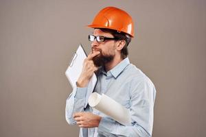 Engineer in an orange helmet shirt safety professional service beige background photo