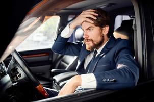 businessmen in a suit in a car a trip to work rich photo