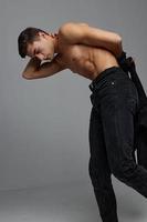 Handsome man in black pants nude torso black shirt studio self-confidence photo