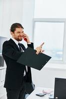 man in a suit holding a phone telephone office technologies photo