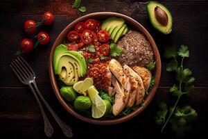 Healthy salad bowl with chicken, avocado, tomatoes, sesame seeds and cilantro photo