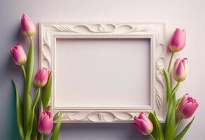 White frame with pink tulips on gray background. Copy space. photo