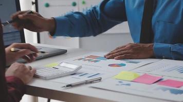 Financial analysts analyze business financial reports on a digital tablet planning investment project during a discussion at a meeting of corporate showing the results of their successful teamwork. video