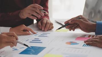 Financial analysts analyze business financial reports on a digital tablet planning investment project during a discussion at a meeting of corporate showing the results of their successful teamwork. video