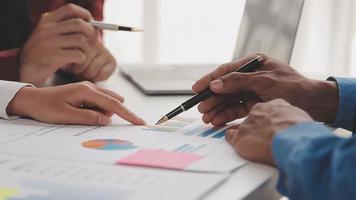 Financial analysts analyze business financial reports on a digital tablet planning investment project during a discussion at a meeting of corporate showing the results of their successful teamwork. video