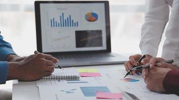 Financial analysts analyze business financial reports on a digital tablet planning investment project during a discussion at a meeting of corporate showing the results of their successful teamwork. video